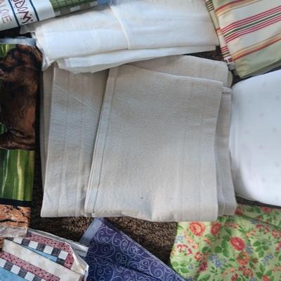 A BOLT AND VARIOUS PIECES OF SEWING MATERIAL