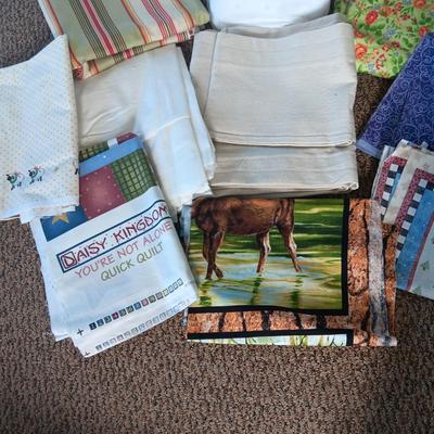 A BOLT AND VARIOUS PIECES OF SEWING MATERIAL