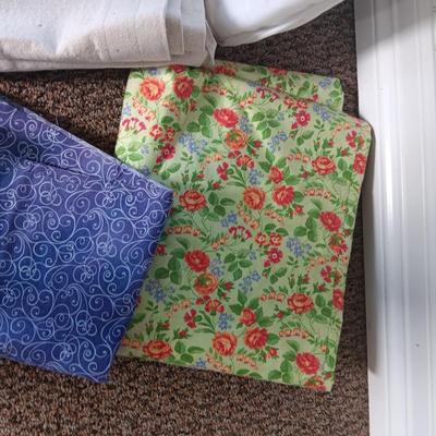 A BOLT AND VARIOUS PIECES OF SEWING MATERIAL