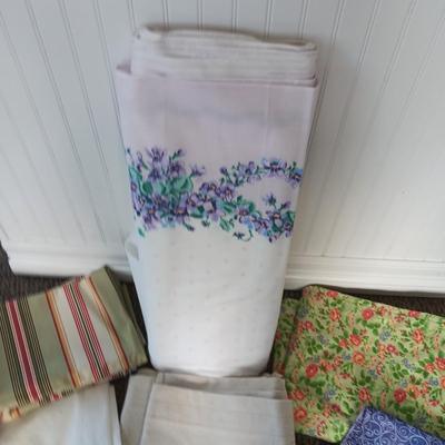 A BOLT AND VARIOUS PIECES OF SEWING MATERIAL