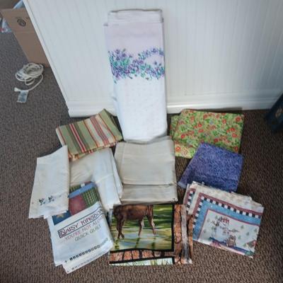 A BOLT AND VARIOUS PIECES OF SEWING MATERIAL