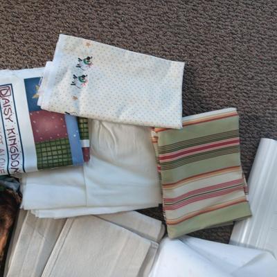 A BOLT AND VARIOUS PIECES OF SEWING MATERIAL