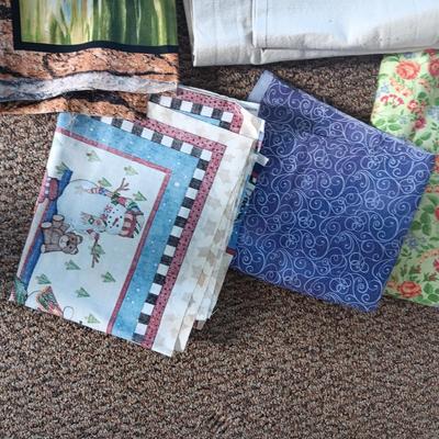 A BOLT AND VARIOUS PIECES OF SEWING MATERIAL