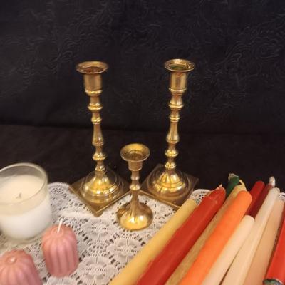 BRASS CANDLESTICKS AND TAPERED CANDLES
