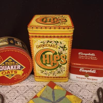 2 CAST IRON TRIVETS, CLAY HOT PLATE AND TINS
