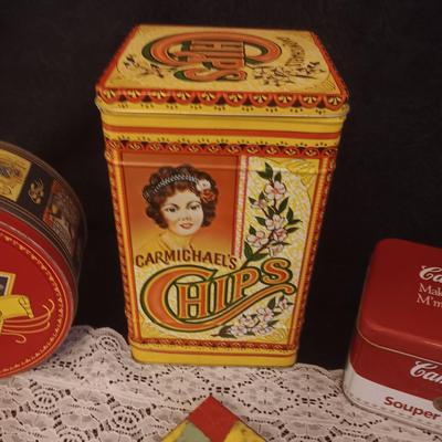 2 CAST IRON TRIVETS, CLAY HOT PLATE AND TINS