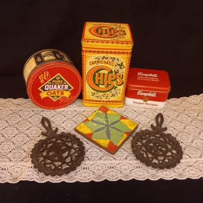 2 CAST IRON TRIVETS, CLAY HOT PLATE AND TINS