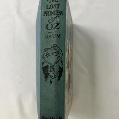 Sale Photo Thumbnail #125: By Frank Baum. No dust jacket. Spine is intact. There is some previous owner's handwriting on the front page in pencil. Measurement: 9" x 7". [BS]