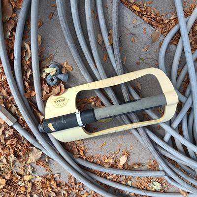 LONG GARDEN HOSE AND SPRINKLERS