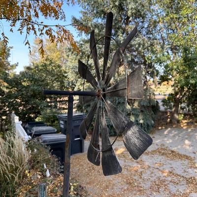 TIN WINDMILL ON A METAL POLE