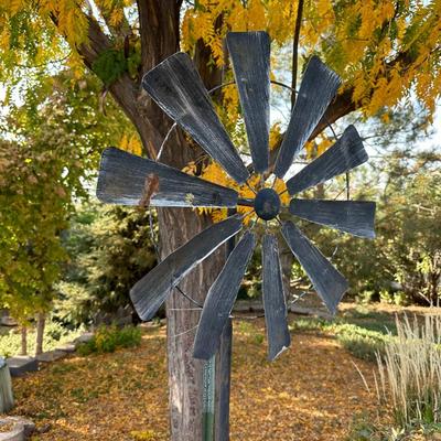 TIN WINDMILL ON A METAL POLE