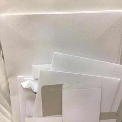 Christmas Themed Gift Bags and White Present Boxes.