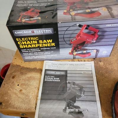 Chain saw sharpener with original box and manual on stand