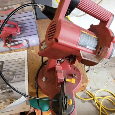 Chain saw sharpener with original box and manual on stand