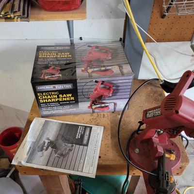 Chain saw sharpener with original box and manual on stand