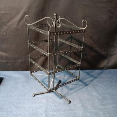 A COLLECTION OF PIERCED EARRINGS AND A ROTATING EARRING HOLDER