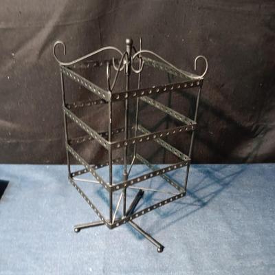 A COLLECTION OF PIERCED EARRINGS AND A ROTATING EARRING HOLDER