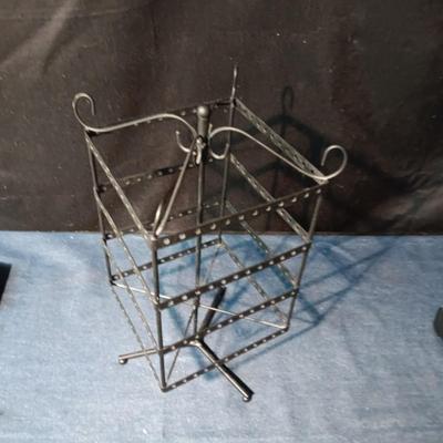 A COLLECTION OF PIERCED EARRINGS AND A ROTATING EARRING HOLDER