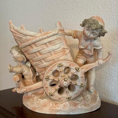 Lot 67 - Unmarked Porcelain Pink Gold Cherub Mother and Child with Cart