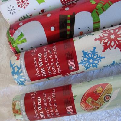 5 rolls Christmas wrapping paper, 2 new in pkg, 3 partially used