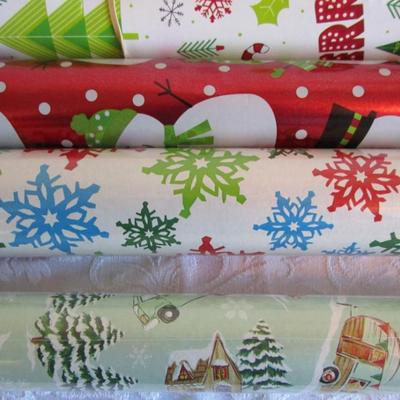 5 rolls Christmas wrapping paper, 2 new in pkg, 3 partially used