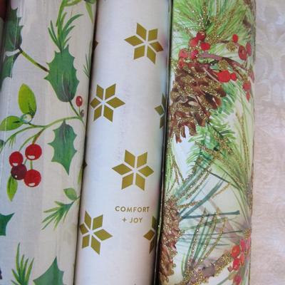 5 rolls Christmas wrapping paper; 3 new, 2 partially used