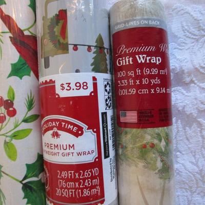 5 rolls Christmas wrapping paper; 3 new, 2 partially used