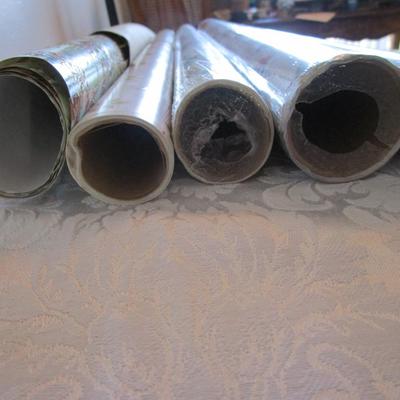 5 rolls Christmas wrapping paper; 3 new, 2 partially used