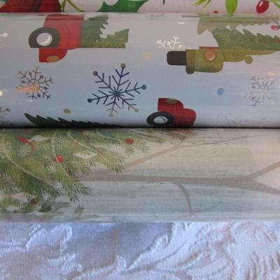 5 rolls Christmas wrapping paper; 3 new, 2 partially used
