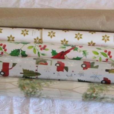 5 rolls Christmas wrapping paper; 3 new, 2 partially used