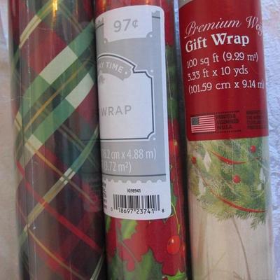3 new rolls of Christmas wrapping paper, 1 Zippered storage bag for gift wrap