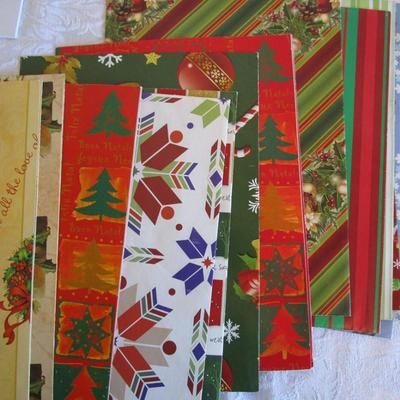 19 folded Christmas gift wrap sheets, 1 pkg Christmas tissue paper, 2 white gift boxes