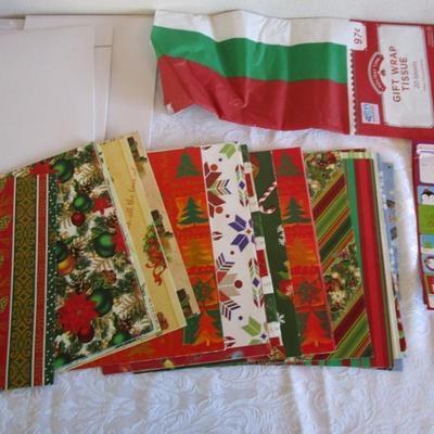 19 folded Christmas gift wrap sheets, 1 pkg Christmas tissue paper, 2 white gift boxes