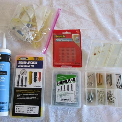 Sale Photo Thumbnail #457: 1 box wood screws various sizes, 1 box assorted anchors, 1 hot glue gun with glue sticks, 1 pkg of clear Scotch mounting tabs, 1 jar of wood filler, 1 tube silicone for window & door siding, 1 box with assorted hardware