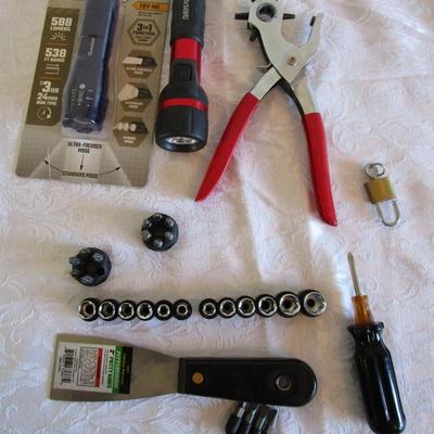 1 new in pkg Quantum flashlight, 1 Rayovac flashlight, 1 phillipis screwdriver, 2 small sets of sockets, 1 rivet tool, 1 small lock with...