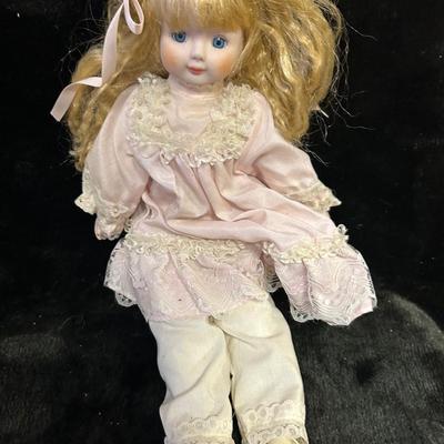 Vintage porcelain doll and stand