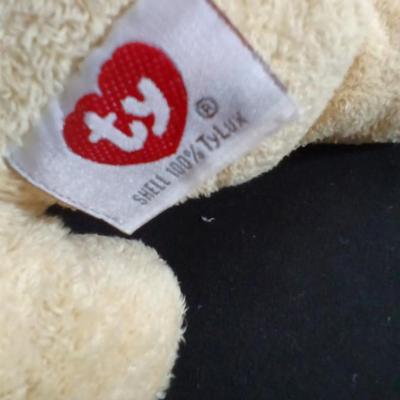 Four Winnie the Pooh books and a TY teddy bear