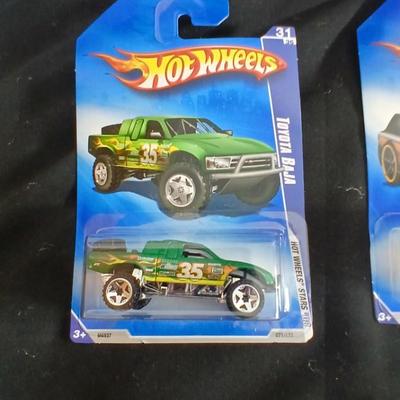 Tonka trucks - and two hot wheels cars in packaging