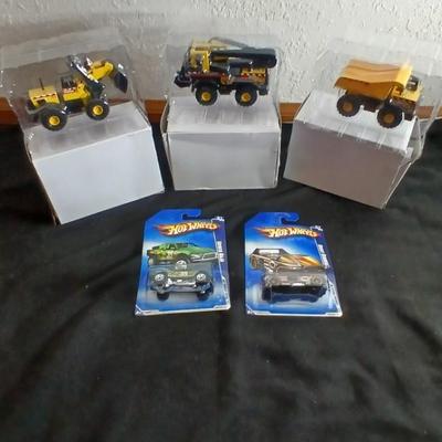 Tonka trucks - and two hot wheels cars in packaging