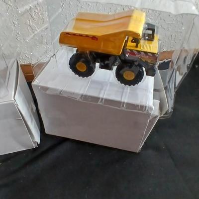 Tonka trucks - and two hot wheels cars in packaging