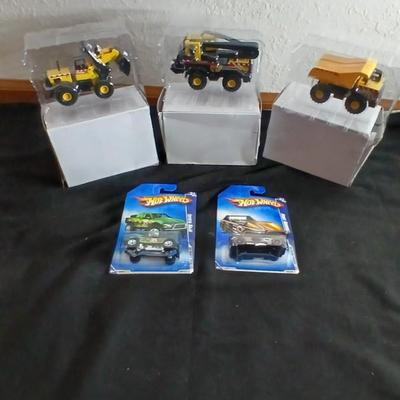 Tonka trucks - and two hot wheels cars in packaging