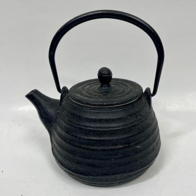 Sale Photo Thumbnail #206: Classic teapot in cast iron with a tea strainer and enameled interior. Suitable for all types of stoves. Pot is 3" tall, measures 6" at the handle.