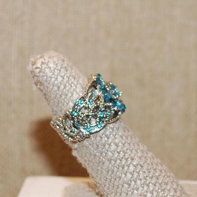 Size 7 Lots of Blue Stones Party Style Ring on a Hollowed Silver Tone Band (7.7g)