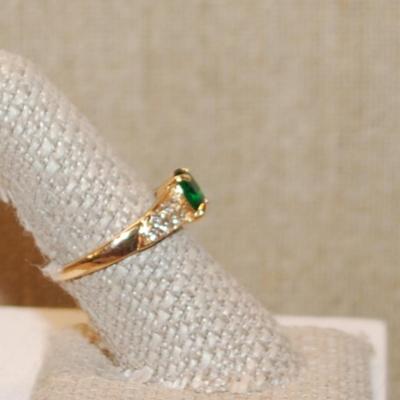 Size 8¾ Green Oval Main Stone Ring with 14 Side Clear Accents Stones on a Gold Tone Band (2.9g)