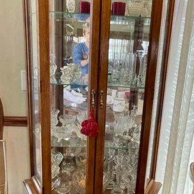 beautiful crystal items in a nice curio cabinet with glass shelves