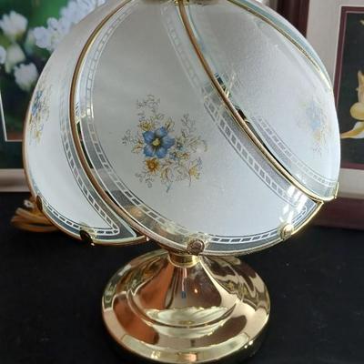 Small touch lamp with framed pictures of Flowers