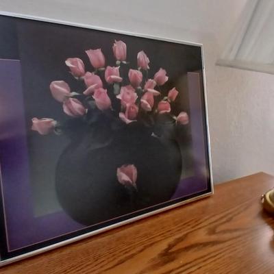 Brass colored table lamp with framed artwork of pink roses