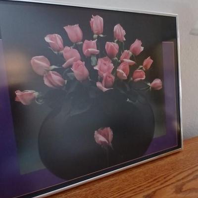 Brass colored table lamp with framed artwork of pink roses