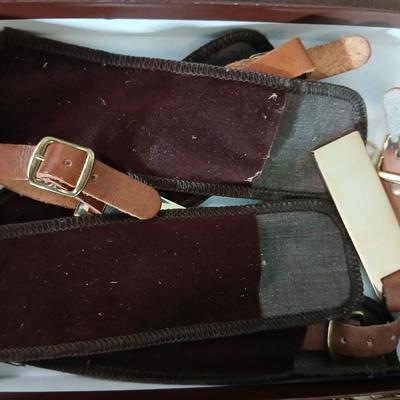 Suitcase with an assortment of bags and a two wheeled adjustable luggage cart