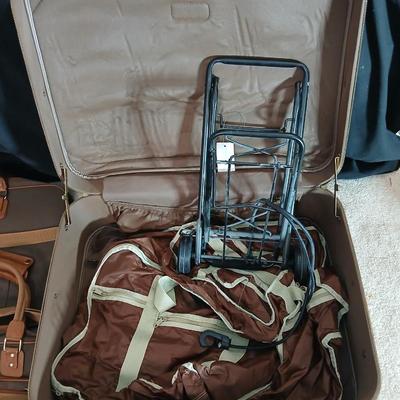 Suitcase with an assortment of bags and a two wheeled adjustable luggage cart